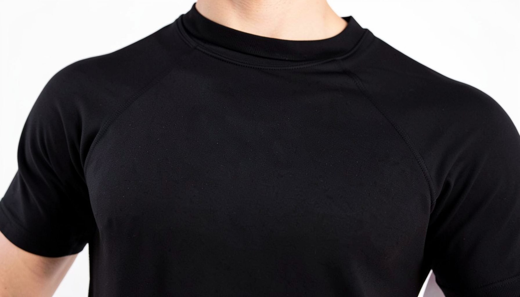 A close-up of a black performance base-layer top, smooth moisture-wicking fabric
